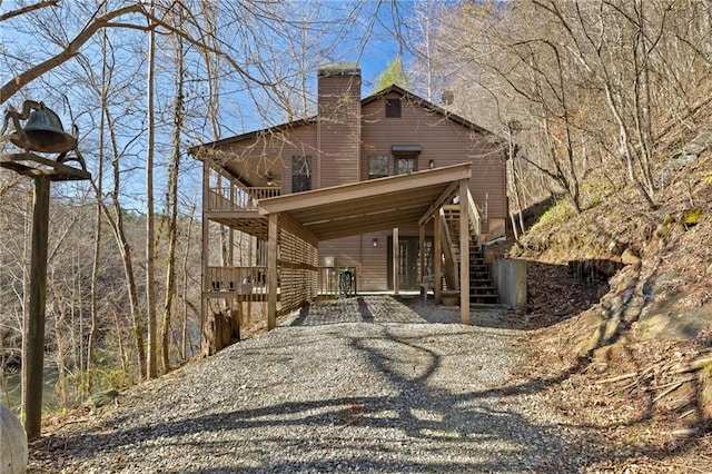 exterior space with a chimney and stairs