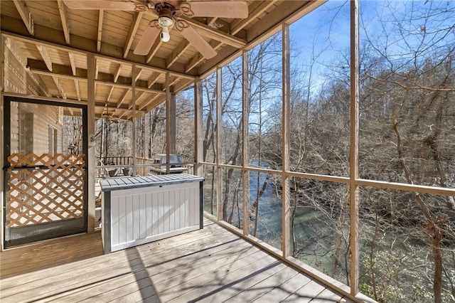 unfurnished sunroom featuring ceiling fan