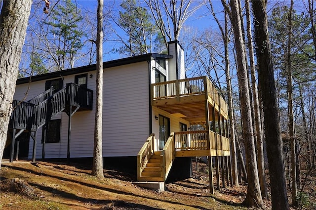 view of property exterior with a wooden deck