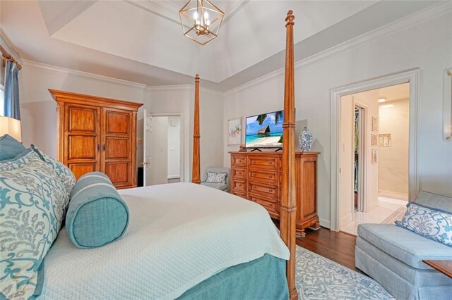 bedroom featuring ornamental molding, wood-type flooring, and a chandelier