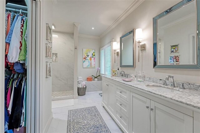 bathroom featuring crown molding, vanity, and tiled shower