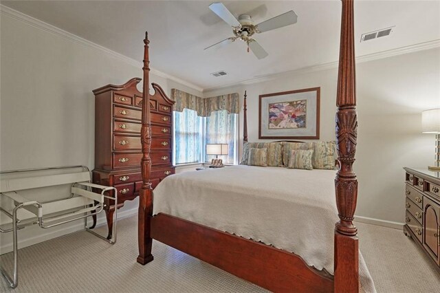 carpeted bedroom featuring ceiling fan and crown molding