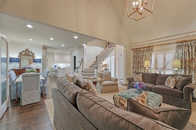 living room with high vaulted ceiling, dark hardwood / wood-style floors, crown molding, and a notable chandelier