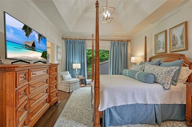 bedroom featuring crown molding, vaulted ceiling, dark hardwood / wood-style floors, and a chandelier