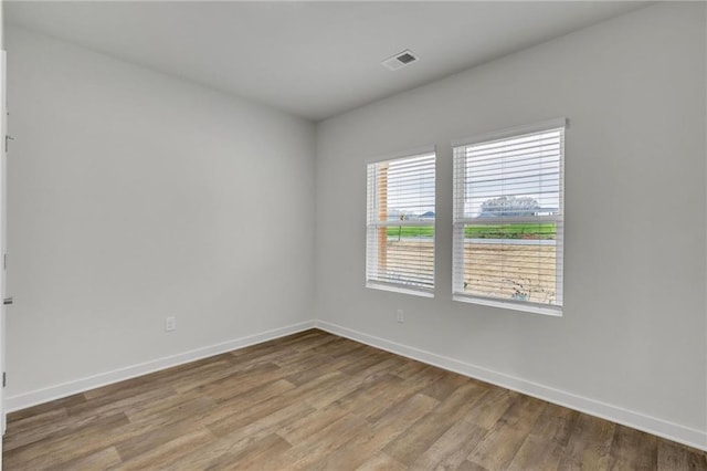 spare room with hardwood / wood-style flooring