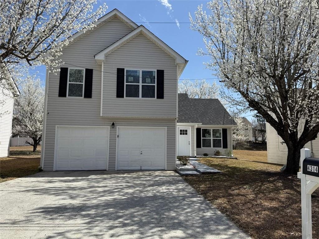 traditional-style home with an attached garage and driveway