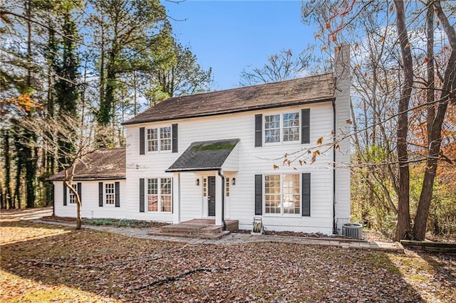 colonial-style house with a chimney and central AC