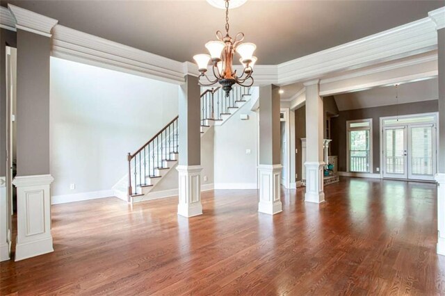 240 Chandler Walk, Loganville, GA 30052 - unfurnished dining area featuring stairway, wood finished floors, a chandelier, and ornamental molding