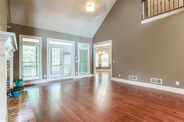 240 Chandler Walk, Loganville, GA 30052 - unfurnished living room featuring a ceiling fan, wood finished floors, and high vaulted ceiling