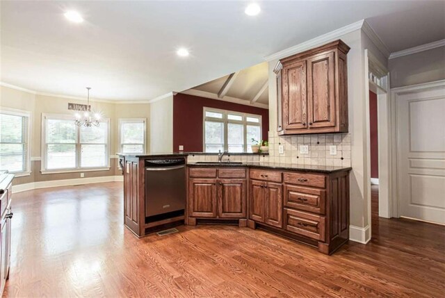 240 Chandler Walk, Loganville, GA 30052 - kitchen with stainless steel dishwasher, a chandelier, brown cabinetry, dark wood finished floors, and recessed lighting