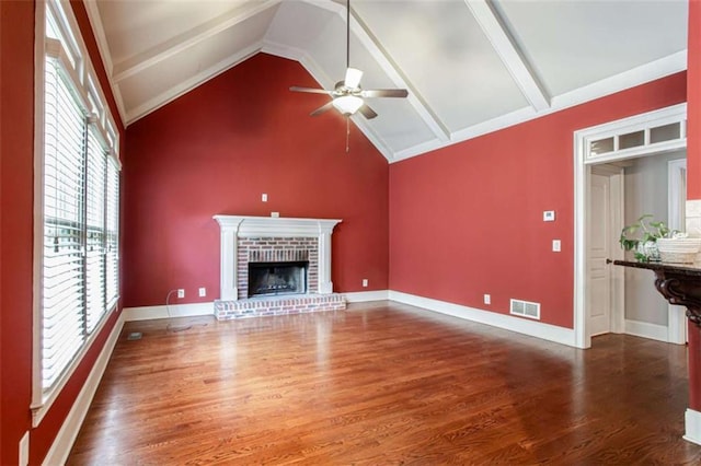 240 Chandler Walk, Loganville, GA 30052 - unfurnished living room with wood finished floors, ceiling fan, a brick fireplace, high vaulted ceiling, and beamed ceiling