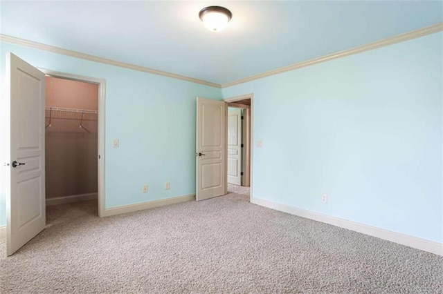 240 Chandler Walk, Loganville, GA 30052 - unfurnished bedroom featuring a spacious closet, ornamental molding, light colored carpet, and a closet