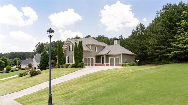 240 Chandler Walk, Loganville, GA 30052 - view of front of home with a front lawn, a chimney, concrete driveway, and an attached garage