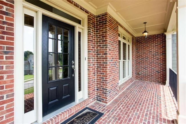 240 Chandler Walk, Loganville, GA 30052 - doorway to property with covered porch and brick siding