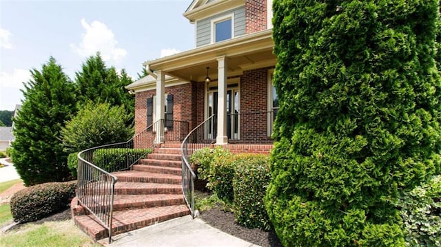 240 Chandler Walk, Loganville, GA 30052 - property entrance with brick siding and covered porch