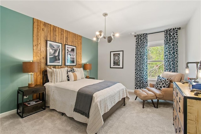 bedroom featuring light carpet, wooden walls, and a chandelier