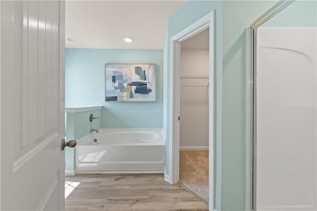 bathroom featuring a tub and wood-type flooring