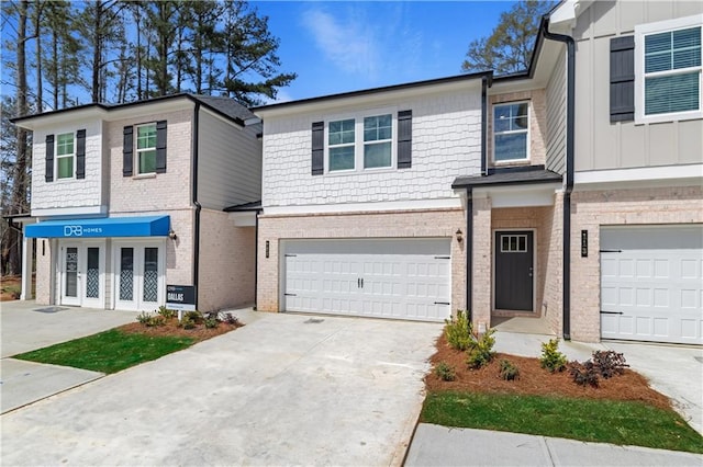 townhome / multi-family property with a garage and french doors