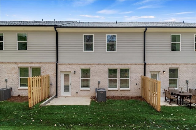 back of house with a lawn, a patio area, and central AC unit