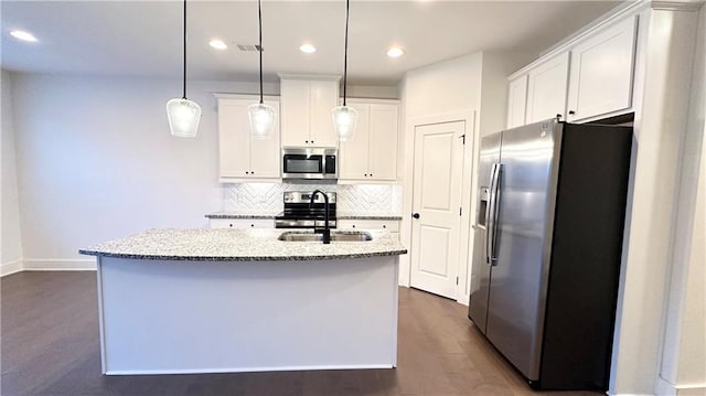 kitchen featuring sink, a center island with sink, hanging light fixtures, appliances with stainless steel finishes, and white cabinets