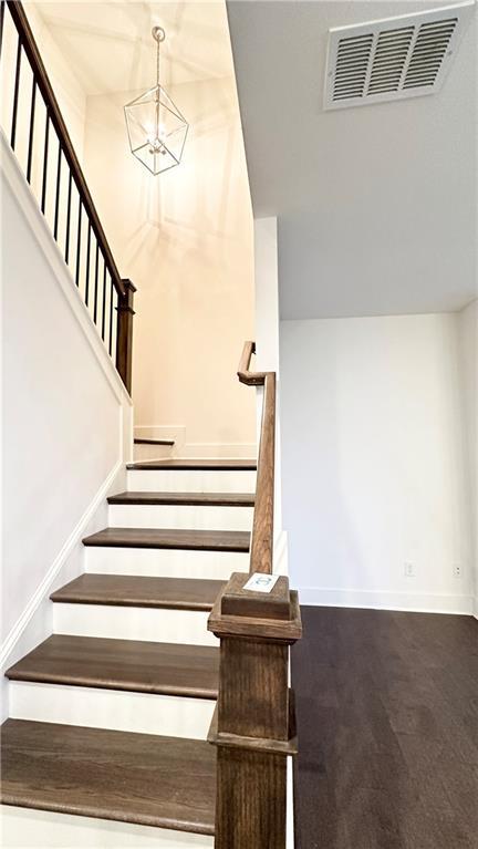 stairs with an inviting chandelier