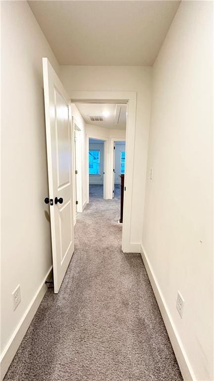 hallway featuring light carpet