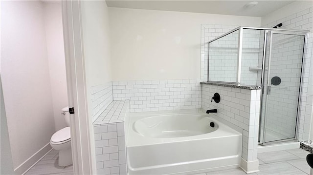 bathroom featuring shower with separate bathtub and toilet