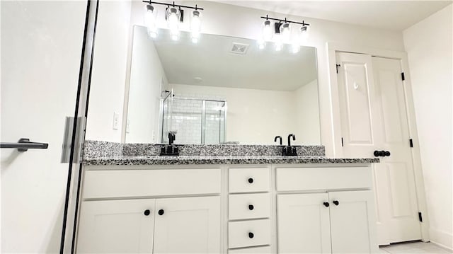 bathroom featuring vanity and an enclosed shower