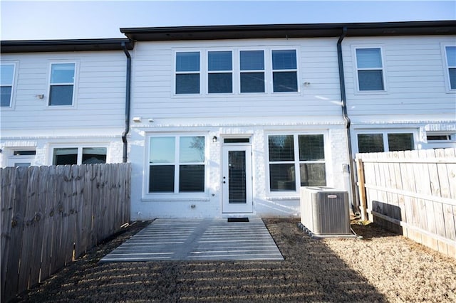 rear view of property featuring cooling unit