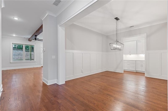 unfurnished dining area featuring crown molding, ceiling fan with notable chandelier, and hardwood / wood-style flooring