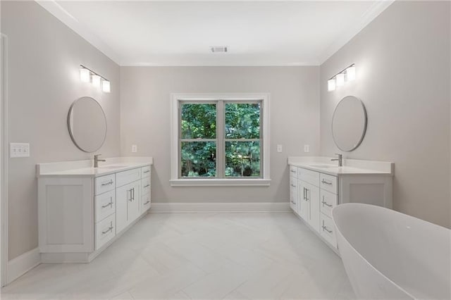 bathroom featuring a tub, crown molding, and vanity