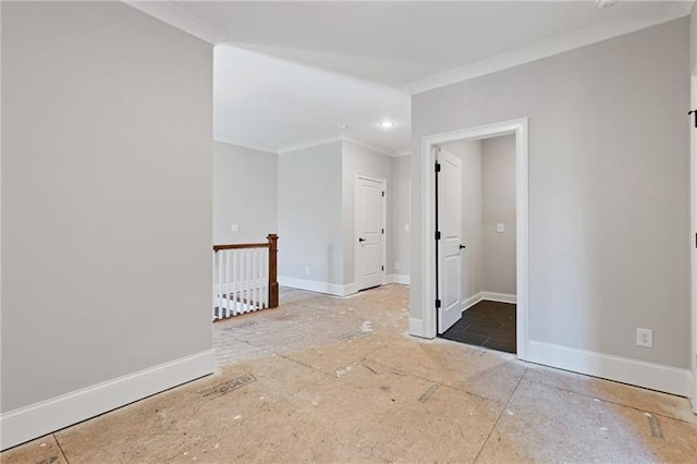 empty room featuring crown molding