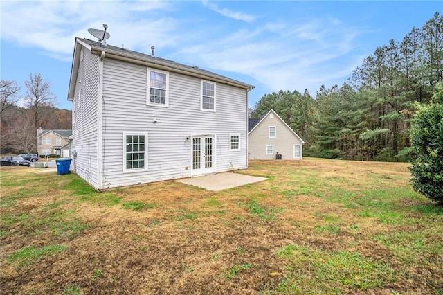 back of house with french doors, a lawn, and a patio area