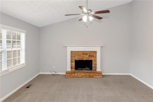 97 Spring Leaf Dr, Dallas, GA 30157 - unfurnished living room featuring a stone fireplace, vaulted ceiling, carpet floors, visible vents, and ceiling fan