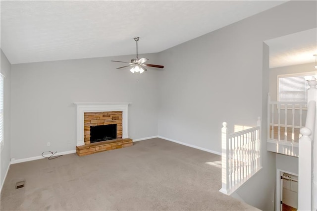 97 Spring Leaf Dr, Dallas, GA 30157 - unfurnished living room with a ceiling fan, a stone fireplace, visible vents, carpet floors, and lofted ceiling