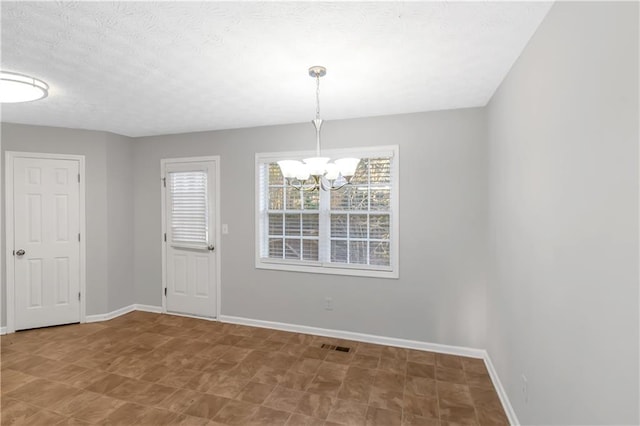 97 Spring Leaf Dr, Dallas, GA 30157 - unfurnished dining area featuring a chandelier, visible vents, baseboards, and a textured ceiling