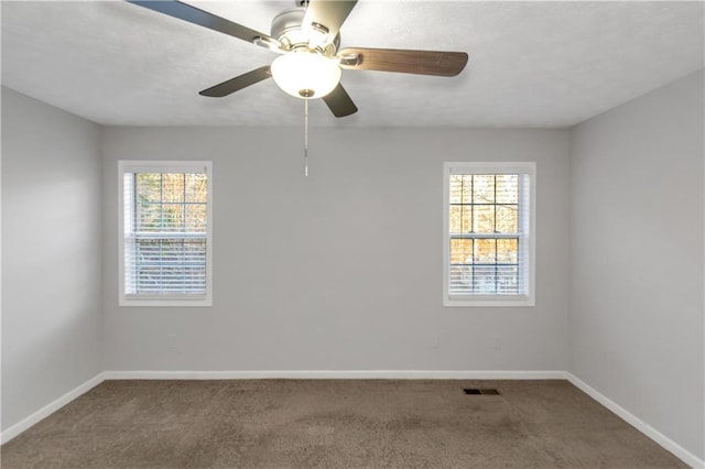 97 Spring Leaf Dr, Dallas, GA 30157 - carpeted empty room featuring visible vents, a wealth of natural light, a ceiling fan, and baseboards