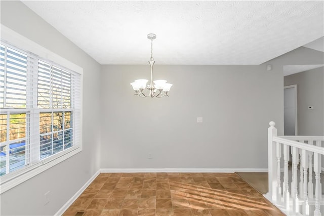 97 Spring Leaf Dr, Dallas, GA 30157 - unfurnished dining area featuring a chandelier, a textured ceiling, baseboards, and visible vents