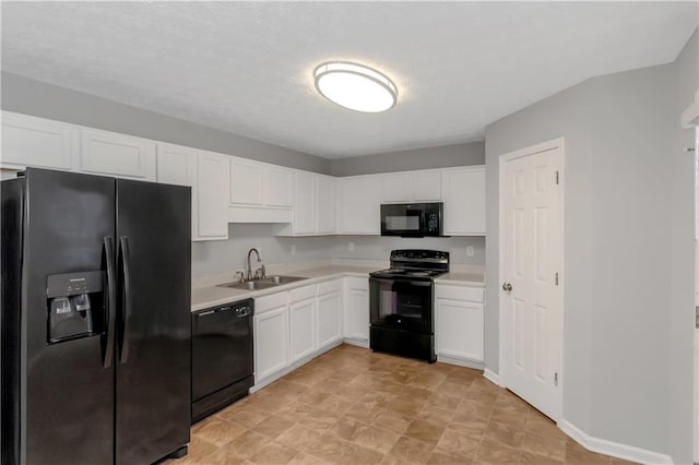 97 Spring Leaf Dr, Dallas, GA 30157 - kitchen with a sink, light countertops, black appliances, and white cabinets