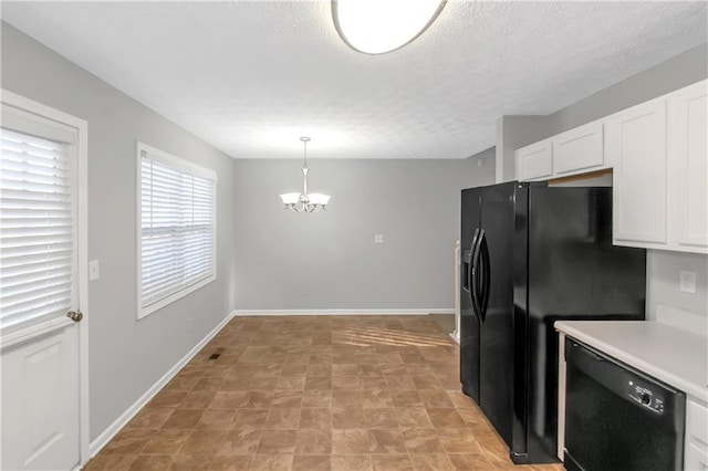 97 Spring Leaf Dr, Dallas, GA 30157 - kitchen with an inviting chandelier, light countertops, white cabinetry, black appliances, and pendant lighting