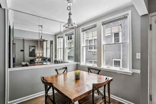 dining area featuring ornamental molding and wood-type flooring