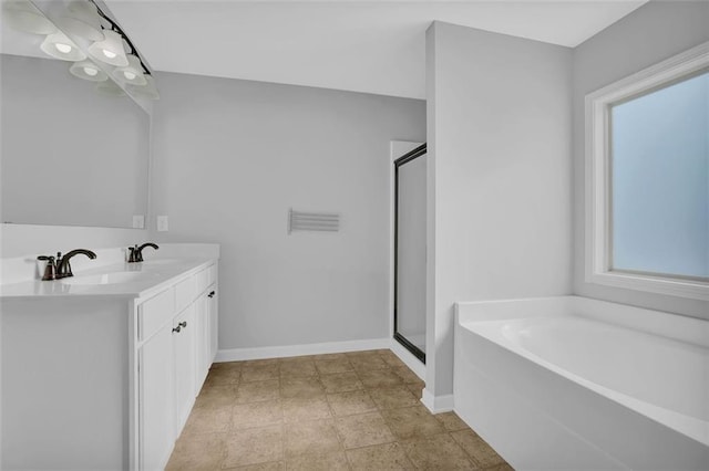 581 Collingsworth Ln, Lawrenceville, GA 30043 - bathroom with a garden tub, a stall shower, double vanity, and baseboards