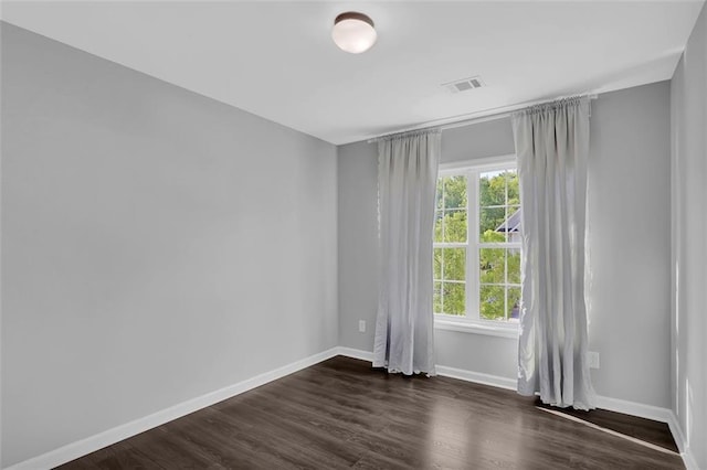 581 Collingsworth Ln, Lawrenceville, GA 30043 - spare room featuring plenty of natural light, dark wood finished floors, and baseboards