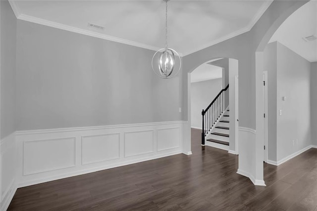 581 Collingsworth Ln, Lawrenceville, GA 30043 - unfurnished dining area featuring a wainscoted wall, dark wood-style flooring, a chandelier, arched walkways, and ornamental molding