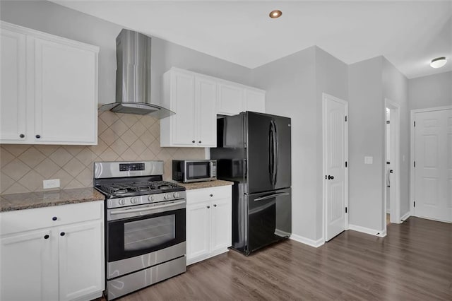 581 Collingsworth Ln, Lawrenceville, GA 30043 - kitchen with stainless steel appliances, wall chimney exhaust hood, dark stone countertops, dark wood-type flooring, and white cabinetry