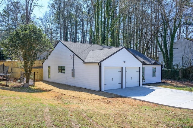 garage with a trampoline and fence