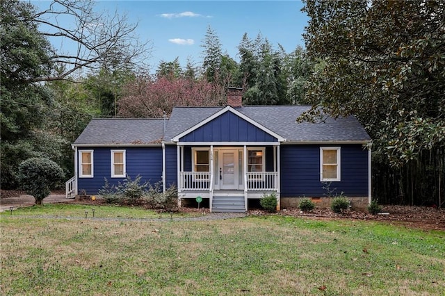 ranch-style home featuring crawl space, a porch, a front lawn, and board and batten siding