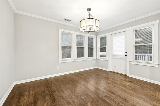 unfurnished dining area featuring a notable chandelier, crown molding, visible vents, dark wood-type flooring, and baseboards