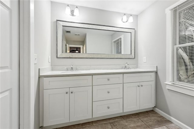 full bath with double vanity, visible vents, and a sink