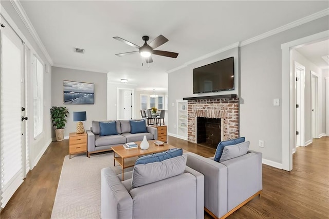 living room with baseboards, visible vents, ornamental molding, and dark wood-type flooring